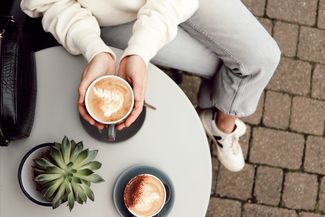Hands around a cup of coffee