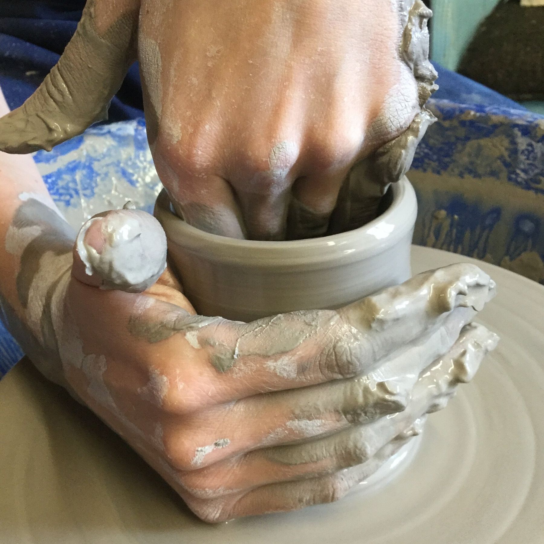 hands making a pot on the potter's wheel at Eastnor Pottery