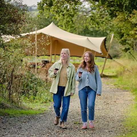 two women walking on vineyard tour