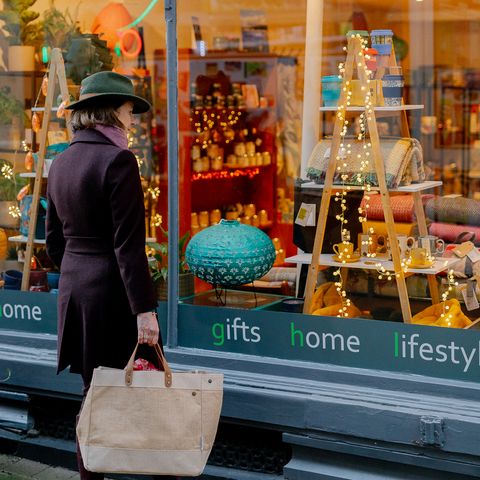 Woman looking through Christmassy shop window