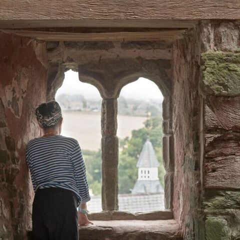Woman looks out over hay castle during herefordshire histories festival