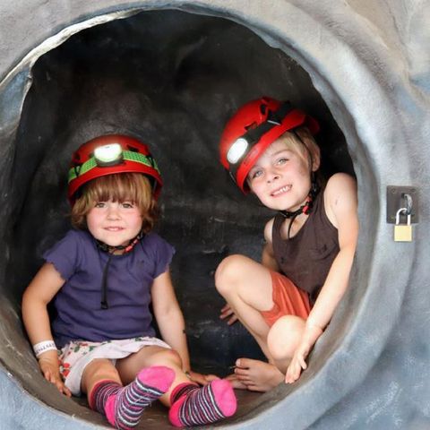 two children trying the mobile caving experience