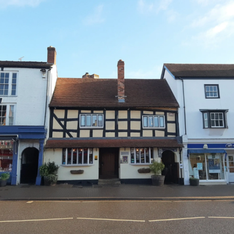 tudor pub nestled into building on a uk high street