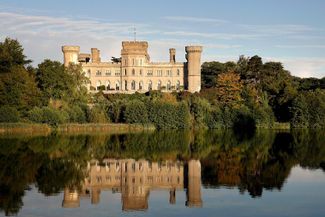 Eastnor castle overlooking a lake
