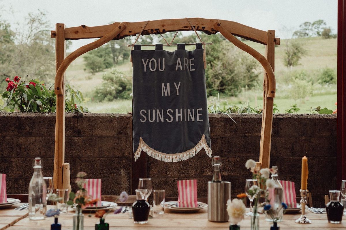 a rustic wedding sign behind the top table