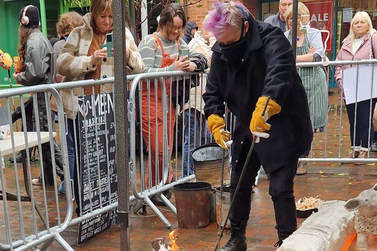 raku pottery being fired as a display outdoors
