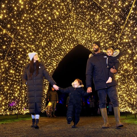 Winter Glow - a family enjoying a walk under a blanket of fairy lights