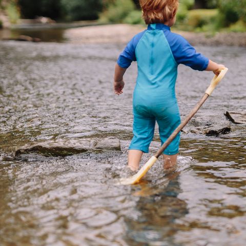 Child paddling in the river