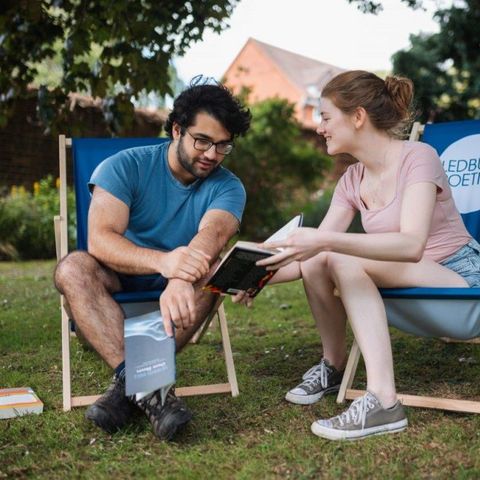 couple on deckchairs reading a book