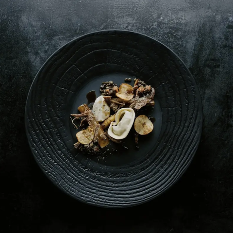 gourmet food styled on black dish 