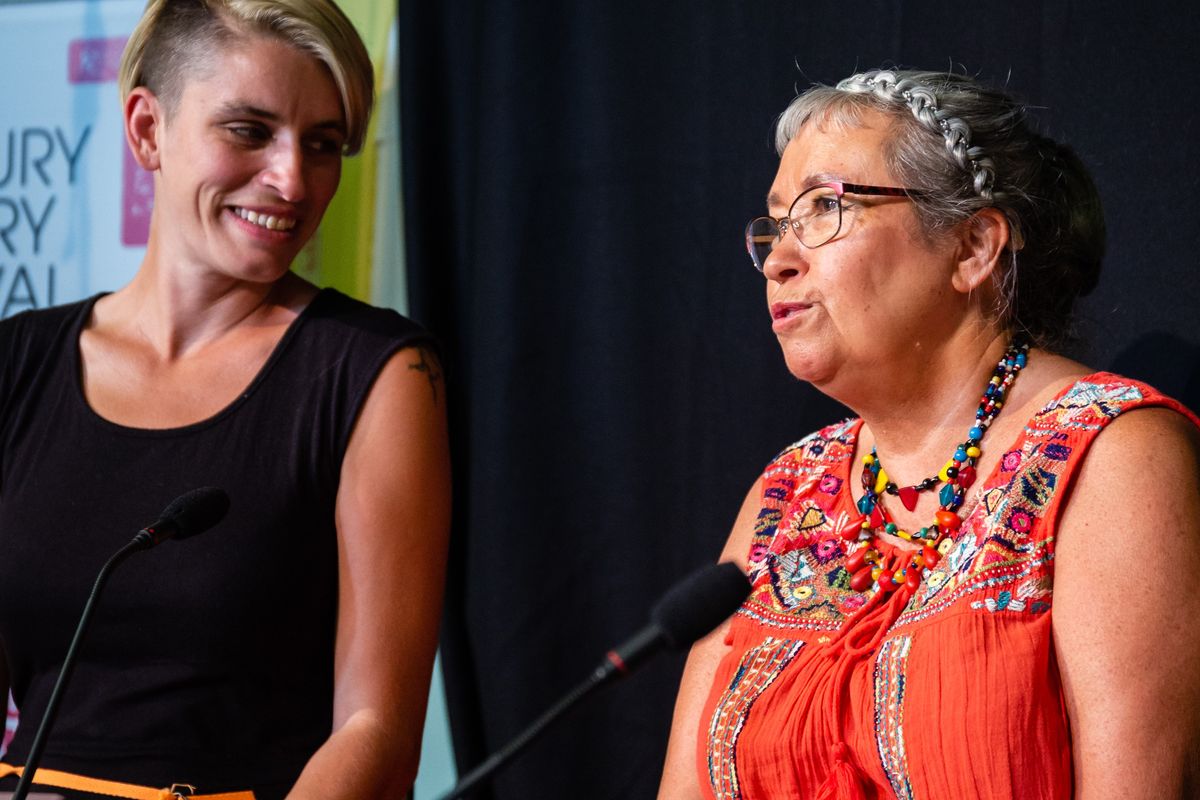 Two people on stage talking