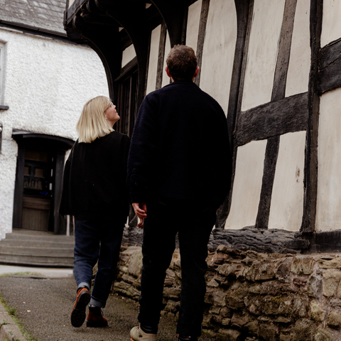 Man and woman walking in black & white village