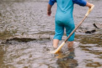 Child paddling in the river