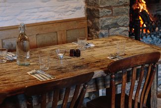 Fireside table set for dinner in country pub