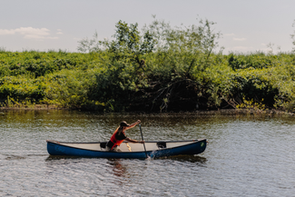 A man canoes down a river
