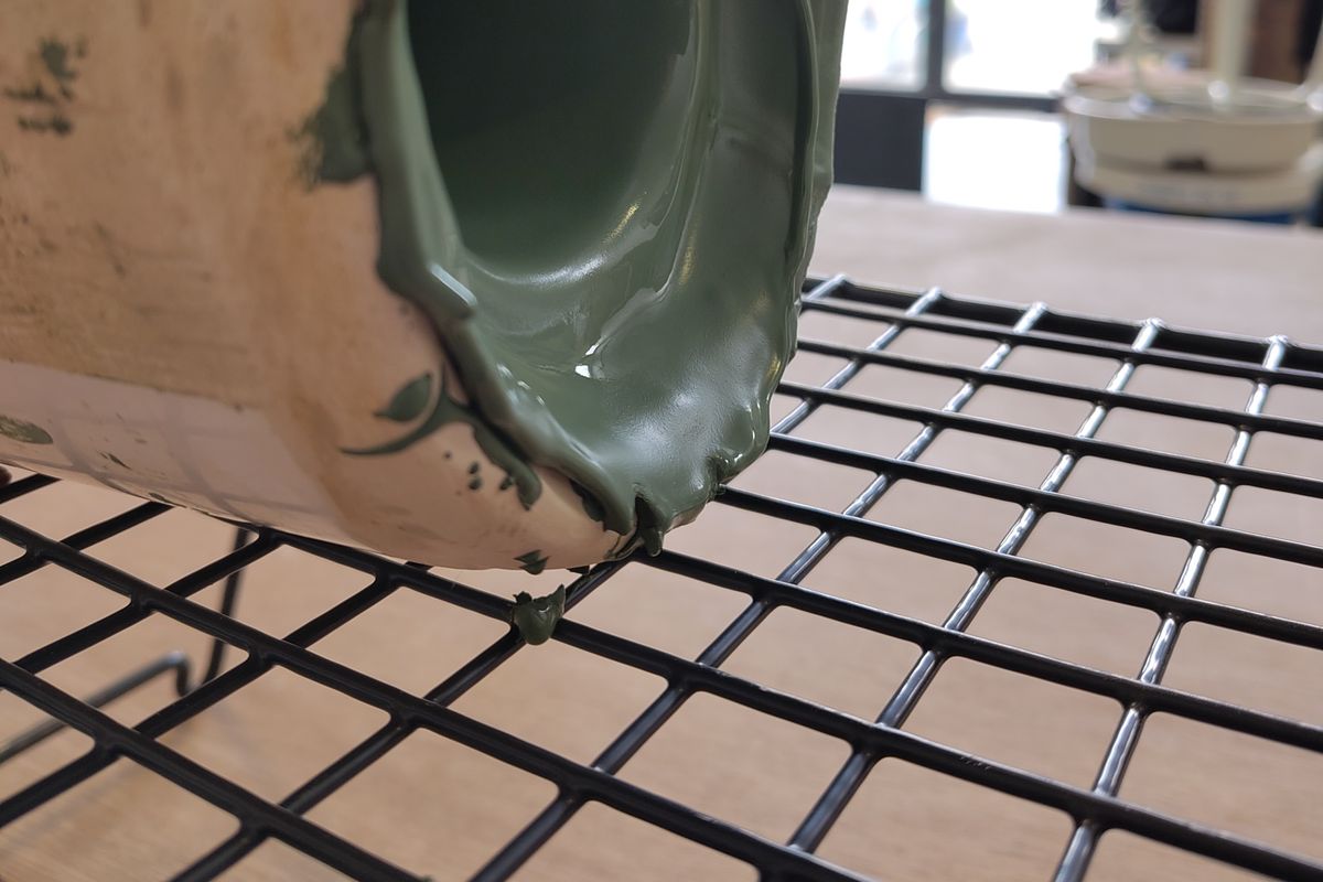 Clay slip pot drying on its side