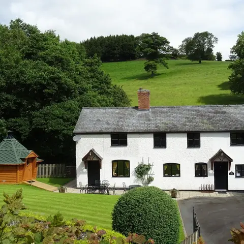 white house cottage set in rural countryside 