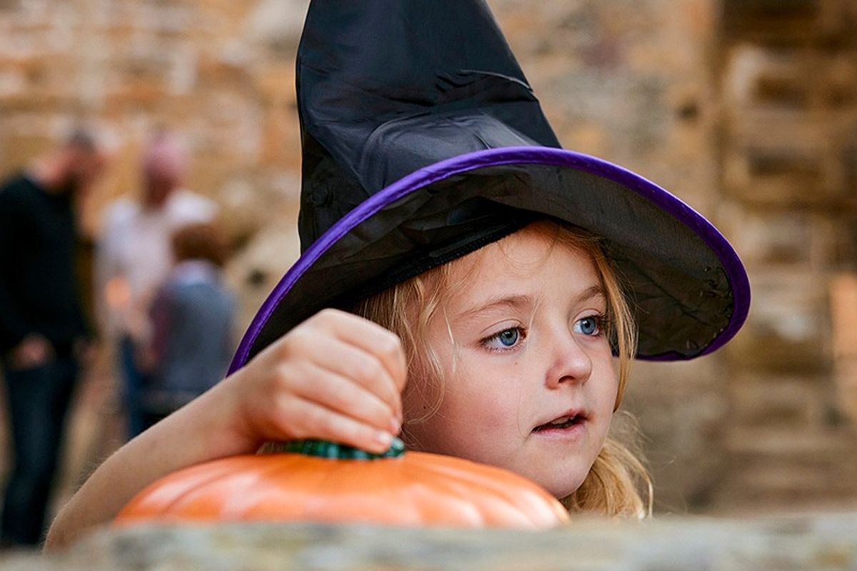 child with black pointy hat