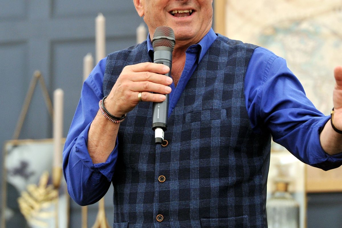 Alan Titchmarsh holding a microphone