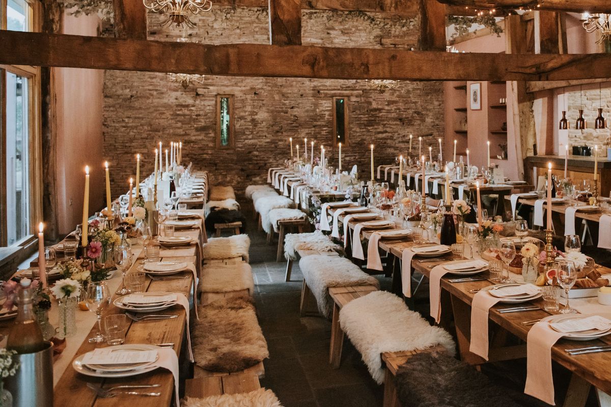 large dining room with wooden furnishings dressed for a country-style wedding