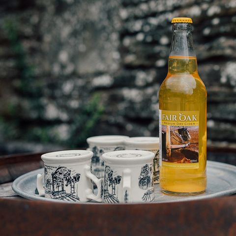 Bottle of Cider with mugs