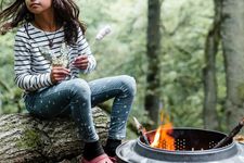 Girl roasts marshmallows in woodland