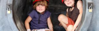 two children trying the mobile caving experience
