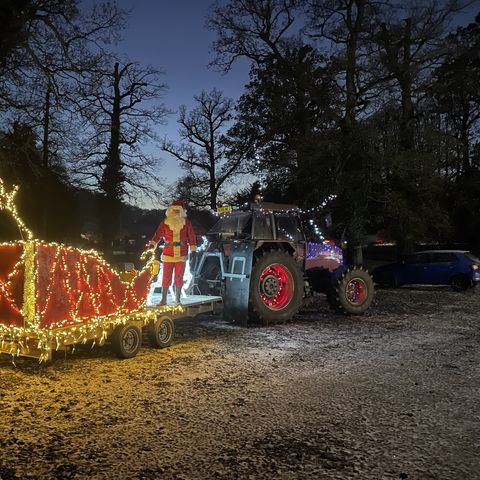 tractor and sledge lit up with fairy lights