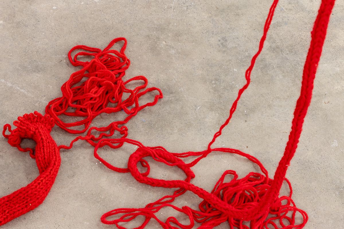 red knitted wool coming undone