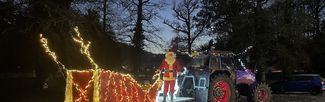 tractor and sledge lit up with fairy lights