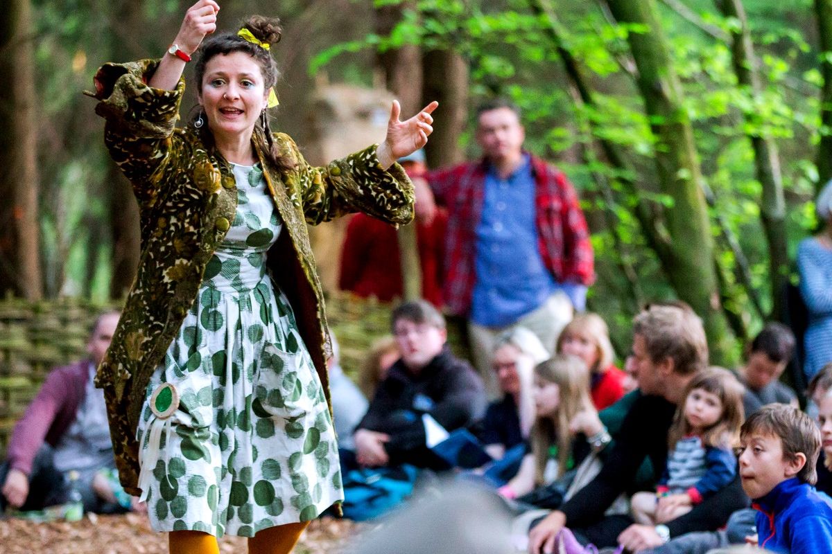 Lady passionately presents to a group in the Woods
