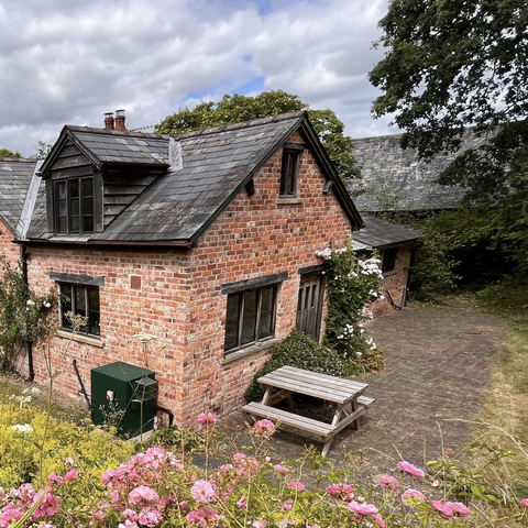 Gardeners cottage with green garden 