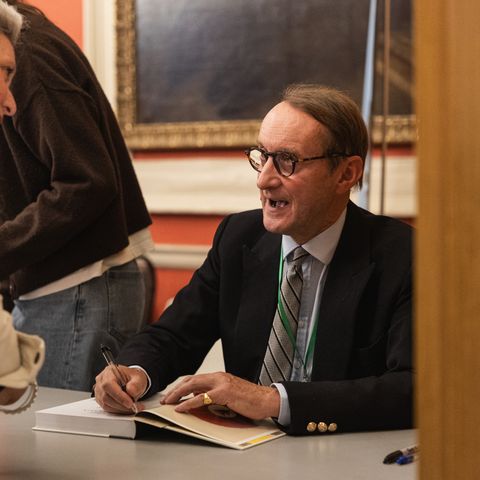 Man signing book at festival