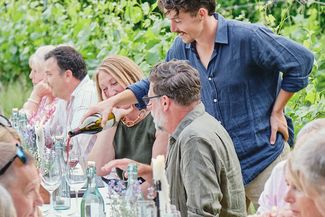 People drinking and dining in the vineyard at Wythall Estate