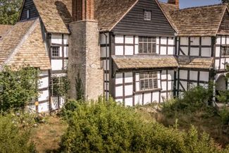 black and white tudor era farm house