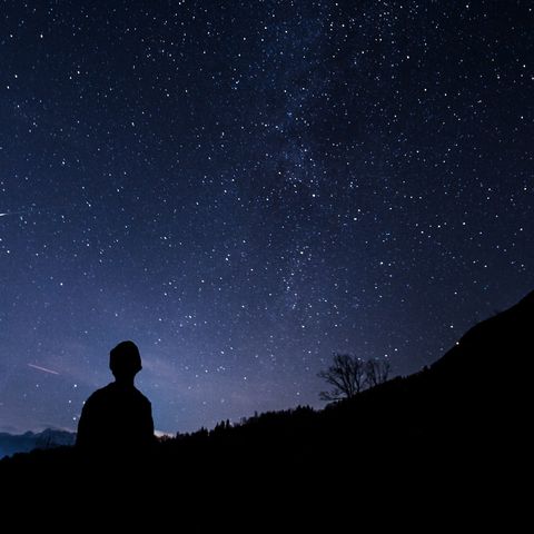 silhouette of person walking at night