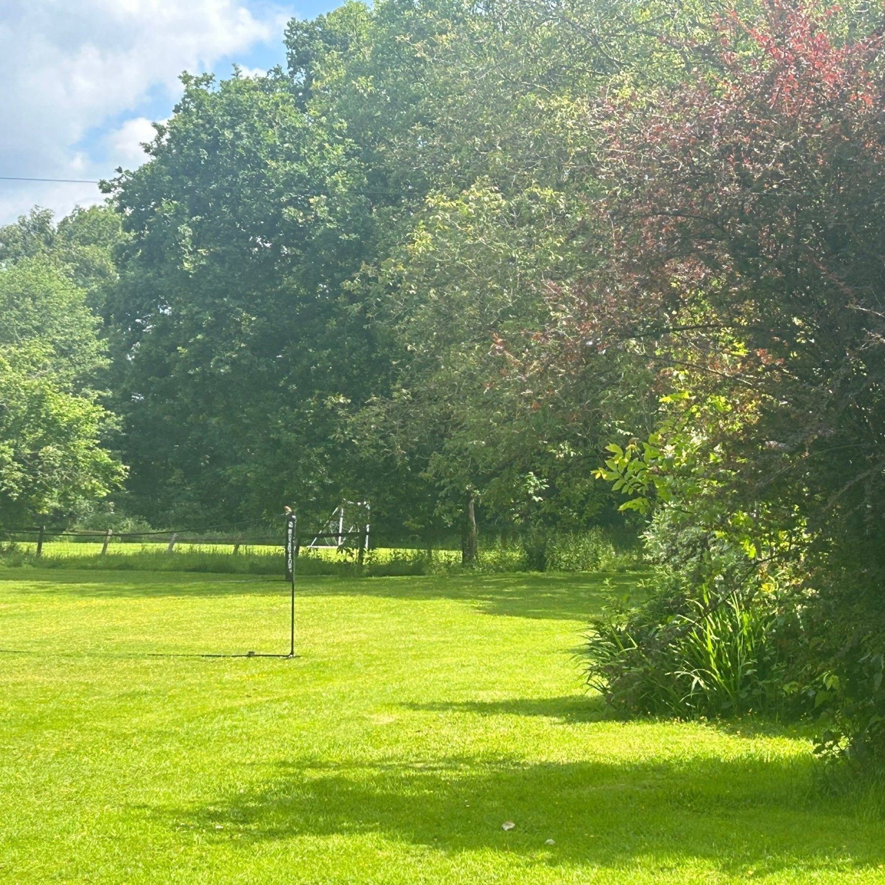 Huge lawns with badminton net and large playing field with football goals