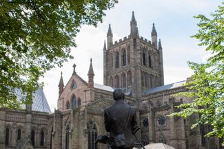 Statue of Elgar with his bicycle looking up at the Cathedral