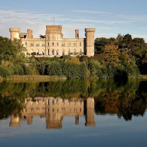 Eastnor castle overlooking a lake