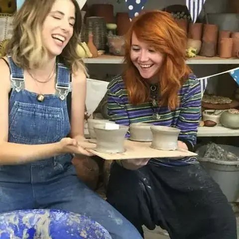 Course participants showing their pottery makes