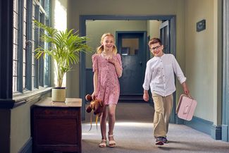 Two children checking in to Green Dragon hotel