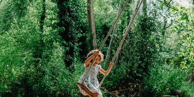 girl on rope swing at Hampton Court castle
