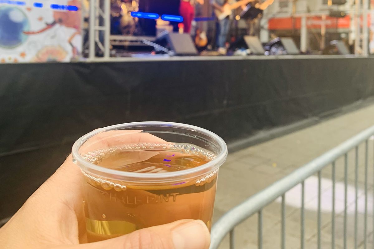 cup of cider in front of stage
