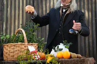 Victorian style dressed man with hamper