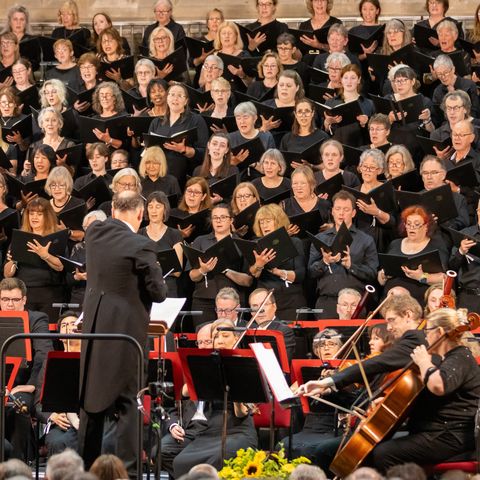 A large choir in black robes 
