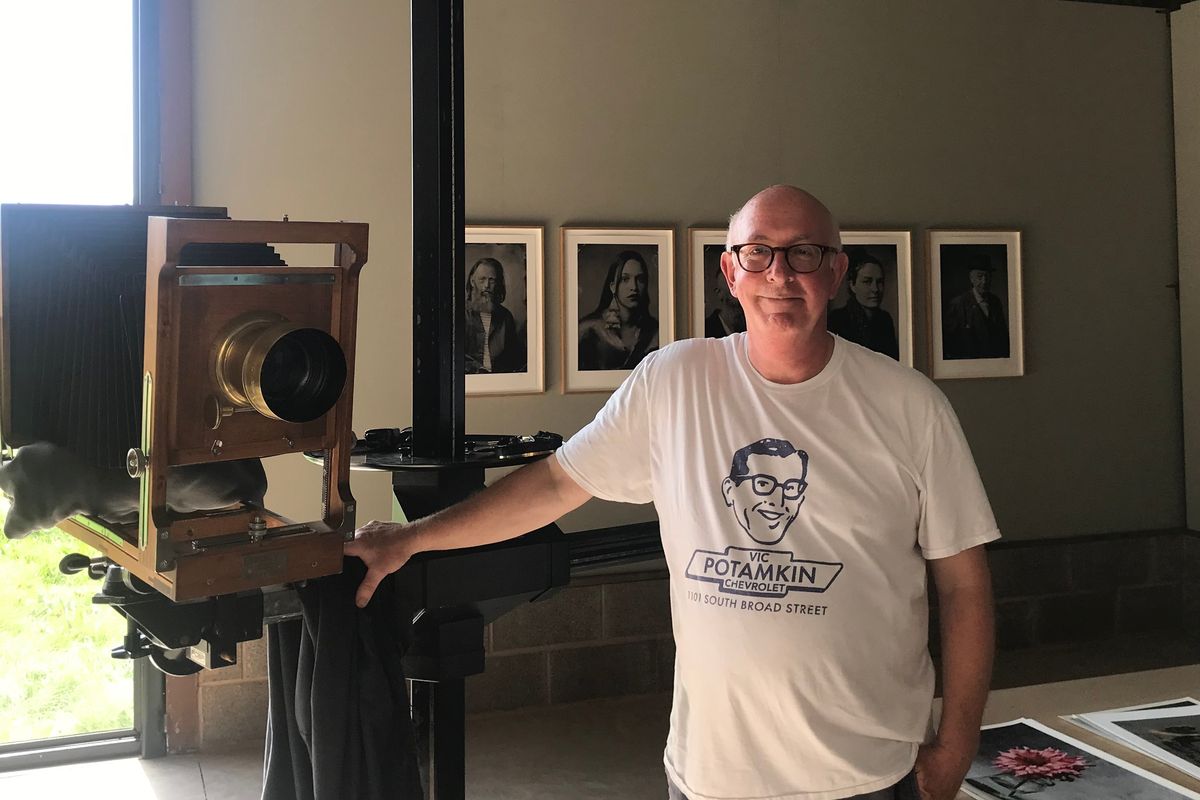 man stood with old fashioned camera