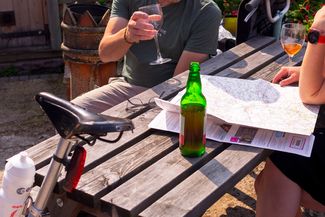 Couple looking over map with cider in hands