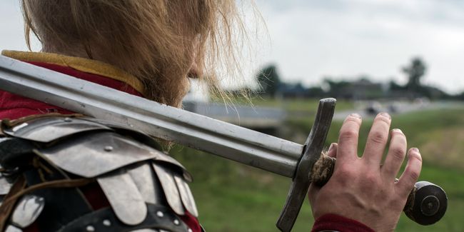 Sword on shoulder of knight