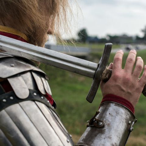 Sword on shoulder of knight