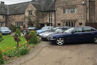 Tudor hotel with cars parked outside the front